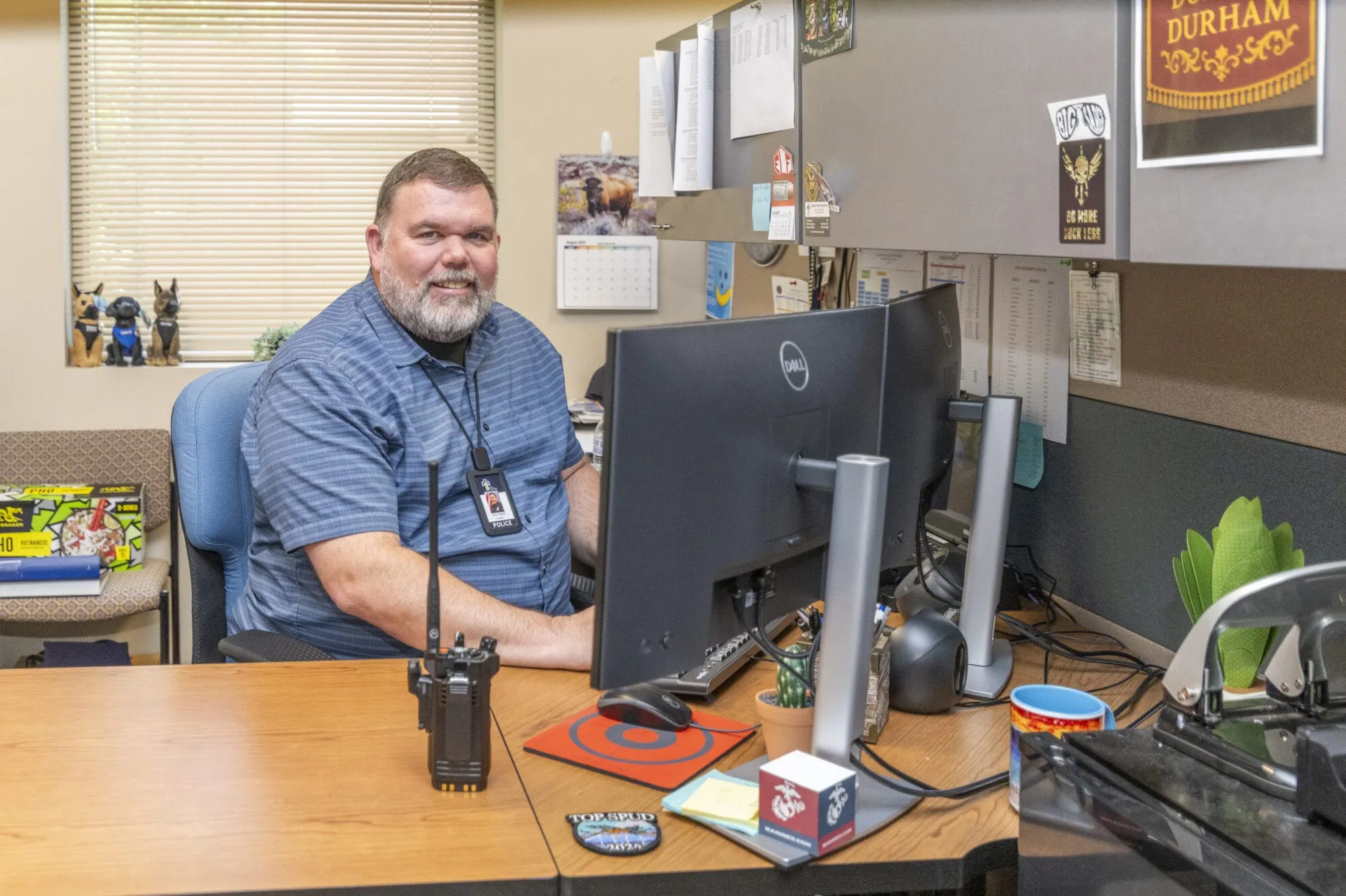 Police Officer sitting at desk looking at computer