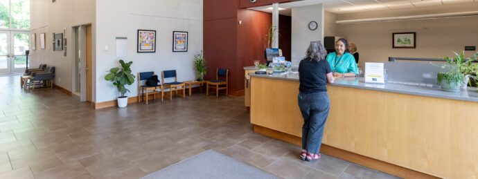 A woman assists a female customer at the Utility Billing desk