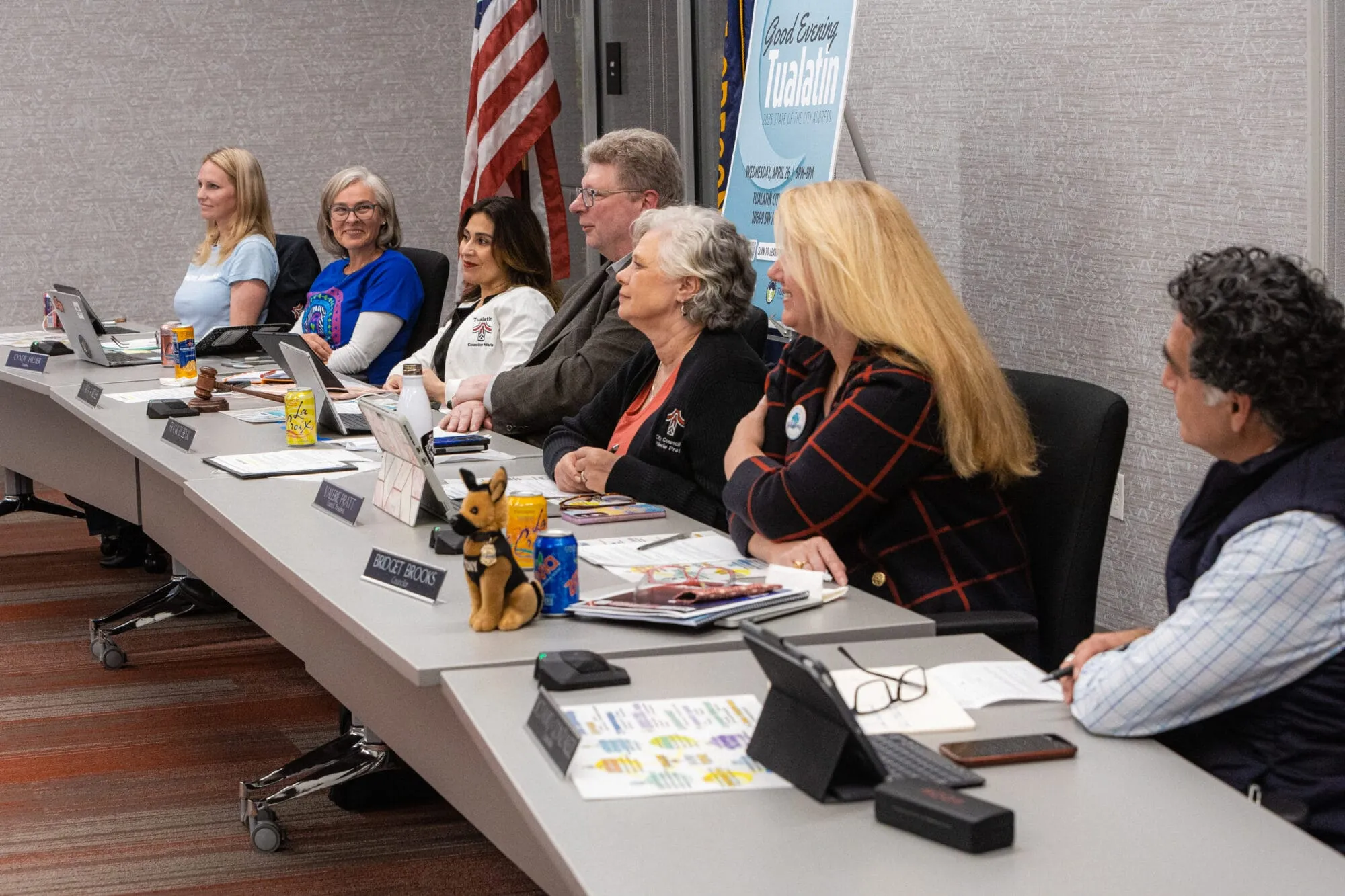 City councilors sitting at table during a meeting