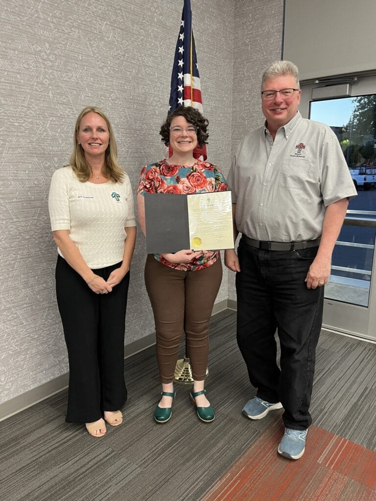 Three people smiling at camera