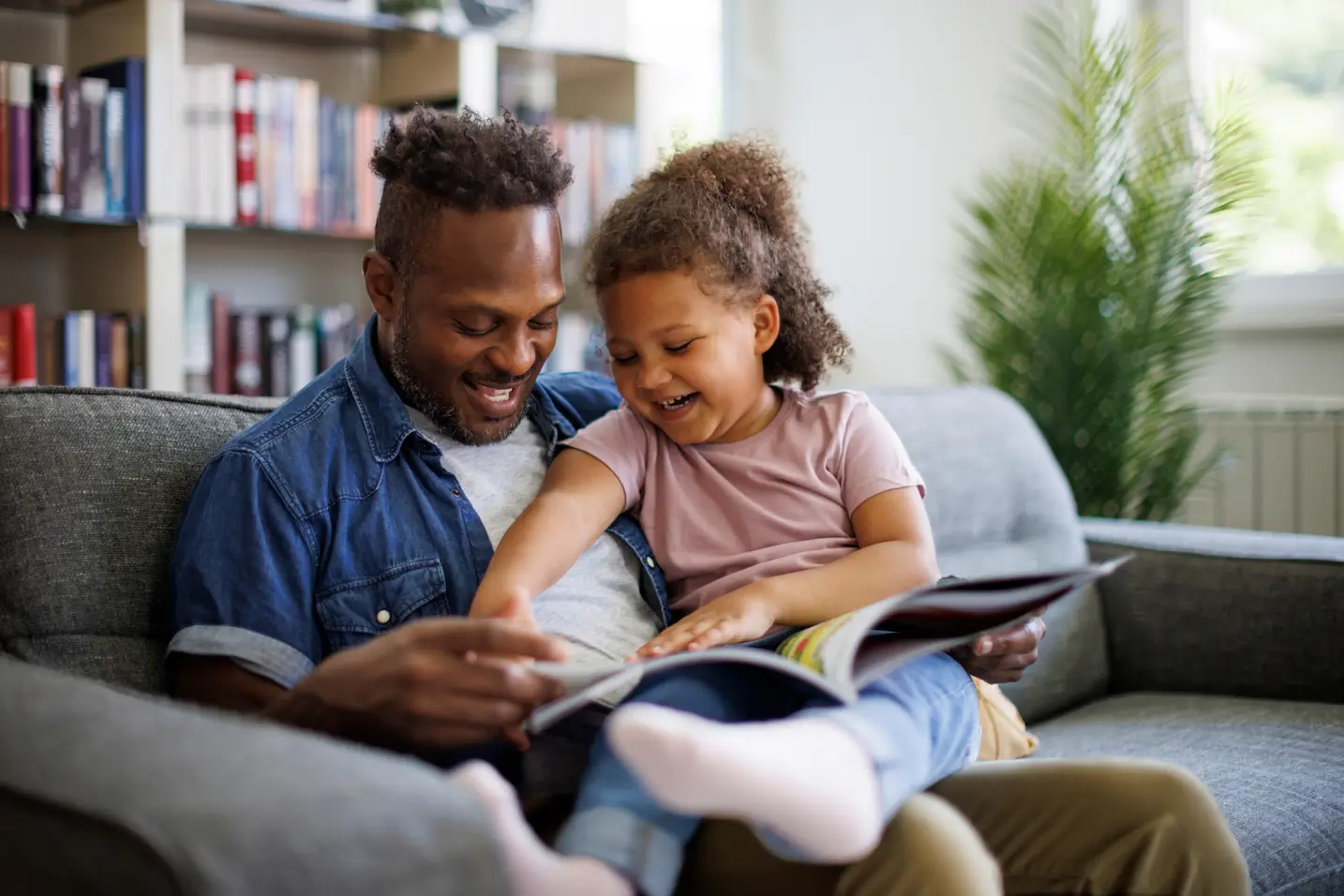Father and daughter reading book
